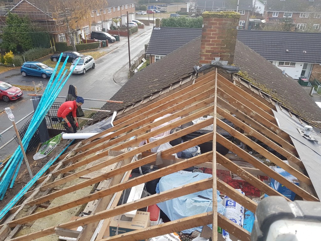 Roof stripped to exposed rafters during re-roofing in Langley Green