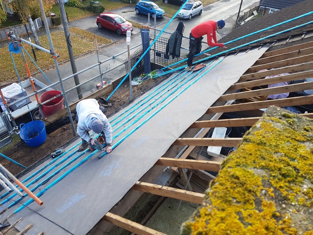 Team fitting breathable roofing membrane and new battens on a Crawley roof